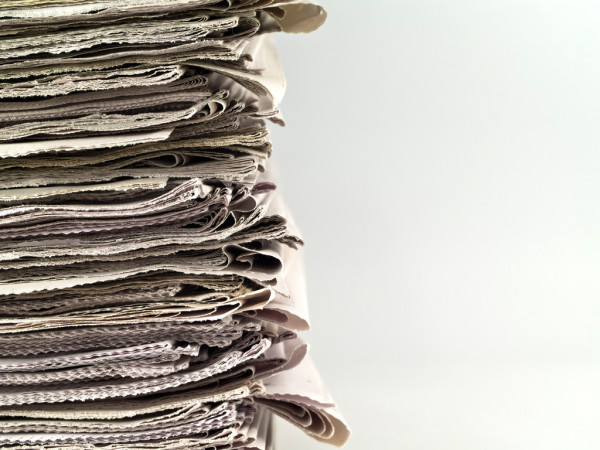 depositphotos_5118563-stock-photo-old-newspapers-stacked-from-the.jpg